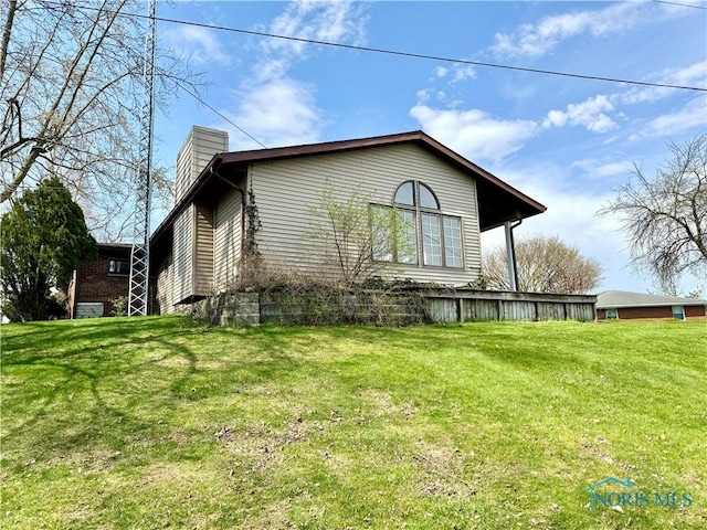 1965 Colwell Cir, Defiance, OH 43512 - view of side of property featuring a lawn and a chimney