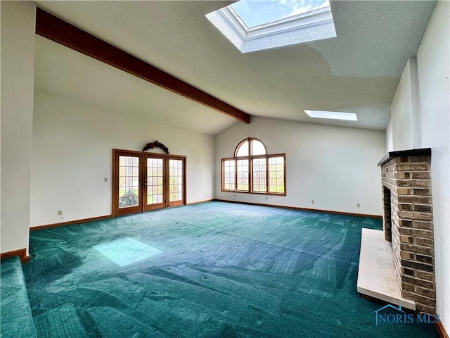 1965 Colwell Cir, Defiance, OH 43512 - unfurnished living room featuring carpet flooring, baseboards, vaulted ceiling with skylight, and a brick fireplace