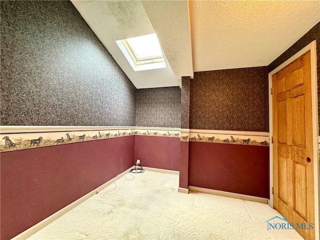 1965 Colwell Cir, Defiance, OH 43512 - interior space with carpet flooring, a textured ceiling, wallpapered walls, and a skylight