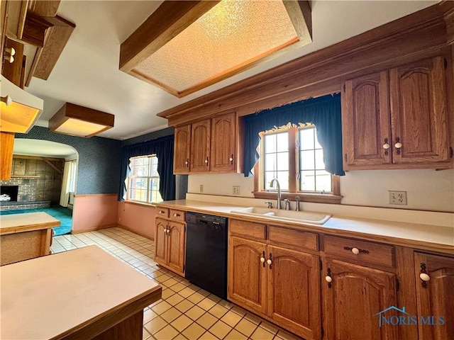 1965 Colwell Cir, Defiance, OH 43512 - kitchen with a sink, black dishwasher, brown cabinetry, light countertops, and light tile patterned floors