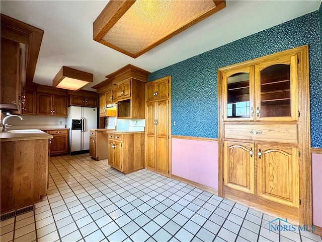 1965 Colwell Cir, Defiance, OH 43512 - kitchen featuring a sink, wallpapered walls, white fridge with ice dispenser, light countertops, and visible vents