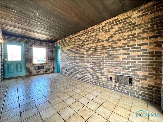 1965 Colwell Cir, Defiance, OH 43512 - unfurnished room featuring wood ceiling and brick wall