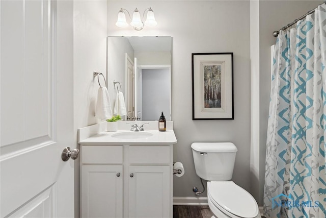 full bath with wood finished floors, vanity, baseboards, toilet, and a shower with shower curtain