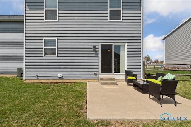 rear view of property featuring a yard, a patio, and central AC unit