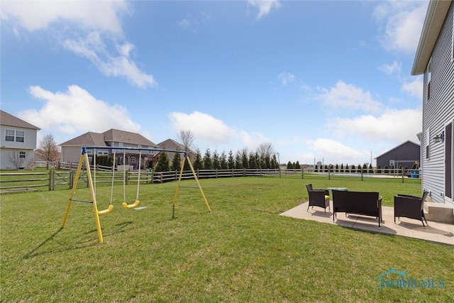 view of yard with a patio area, a fenced backyard, and a playground