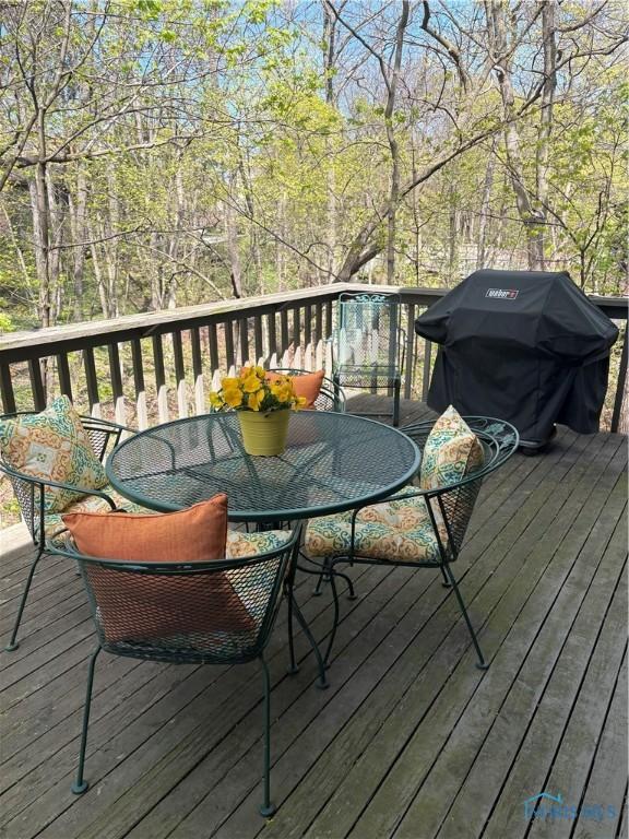 wooden terrace with outdoor dining space