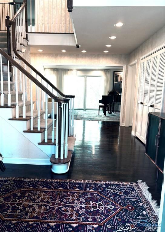 interior space with recessed lighting, wood finished floors, and baseboards