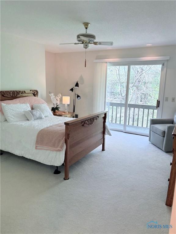 carpeted bedroom with ceiling fan and access to exterior