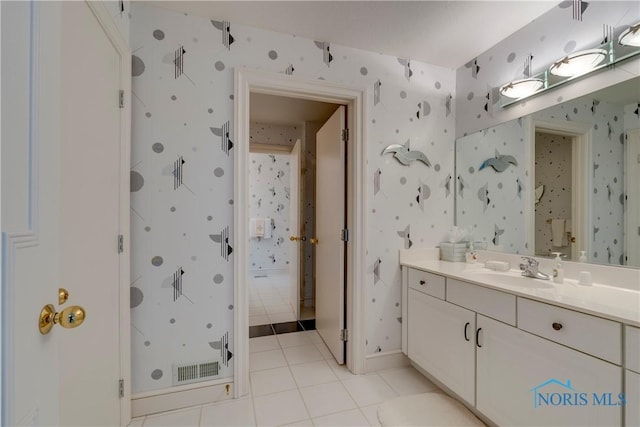 full bath featuring wallpapered walls, baseboards, vanity, and tile patterned floors