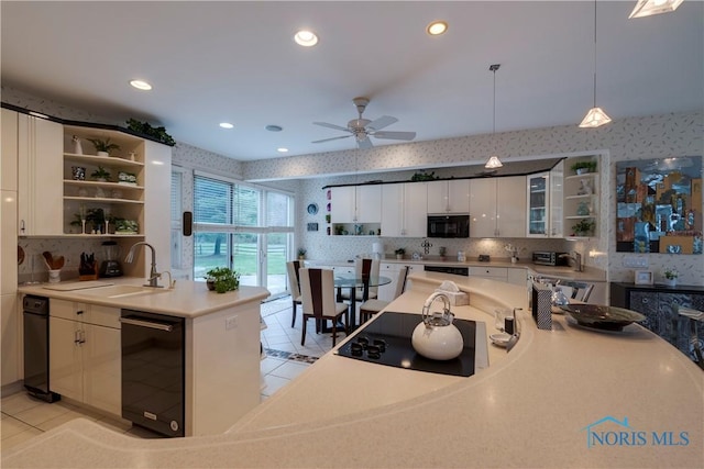kitchen with tasteful backsplash, open shelves, a sink, black appliances, and light tile patterned flooring