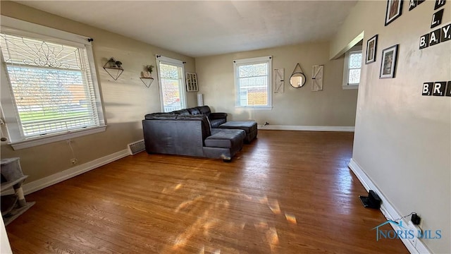 sitting room featuring visible vents, baseboards, and wood finished floors