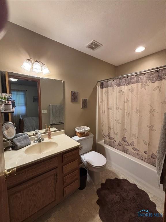 806 Springdale Dr, Paulding, OH 45879 - bathroom with shower / bath combo with shower curtain, toilet, visible vents, and vanity