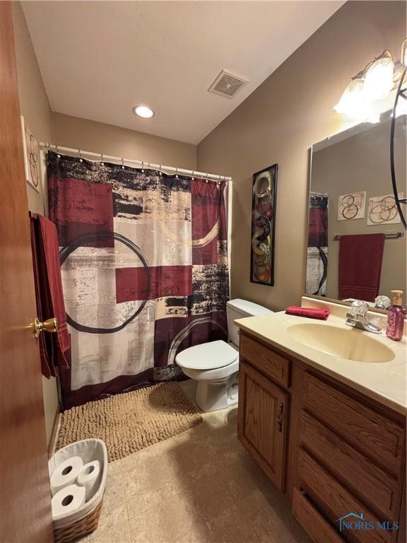 806 Springdale Dr, Paulding, OH 45879 - bathroom with vanity, a shower with curtain, toilet, and visible vents