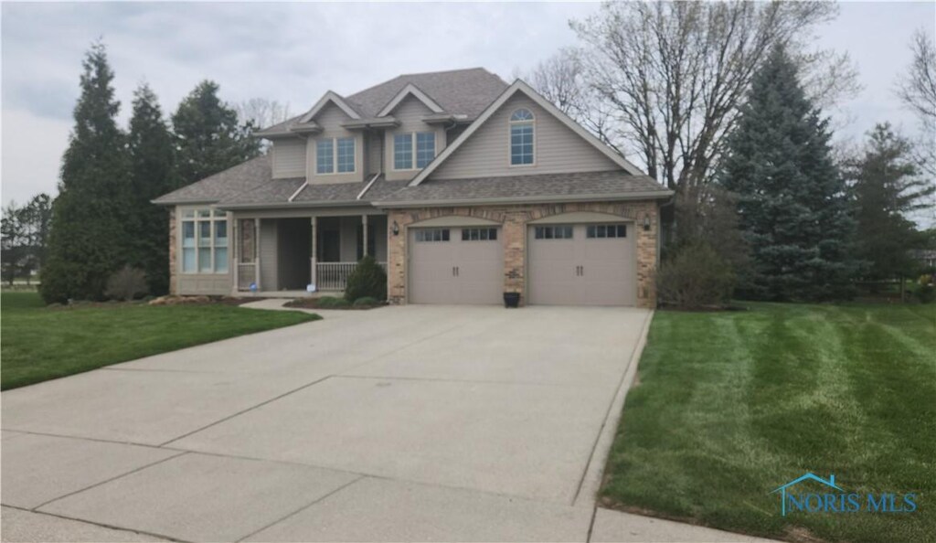 8126 Trent Lock Dr, Waterville, OH 43566 - craftsman inspired home featuring an attached garage, a front yard, concrete driveway, and roof with shingles