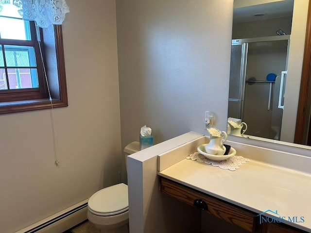 bathroom with a baseboard heating unit, vanity, toilet, and a stall shower