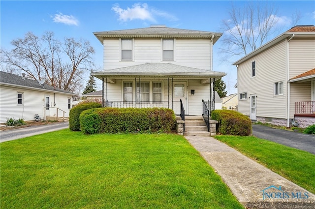 806 W Tiffin St, Fostoria, OH 44830 - american foursquare style home with a front lawn, covered porch, and roof with shingles