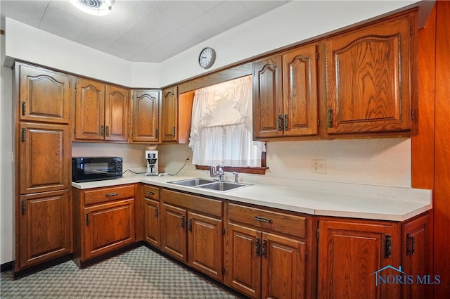 806 W Tiffin St, Fostoria, OH 44830 - kitchen featuring black microwave, light countertops, and a sink