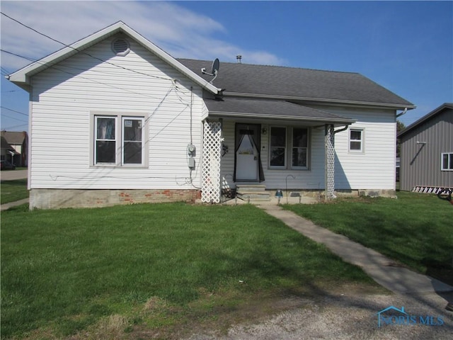 104 S Summit St, Edon, OH 43518 - view of front of home with a shingled roof and a front yard