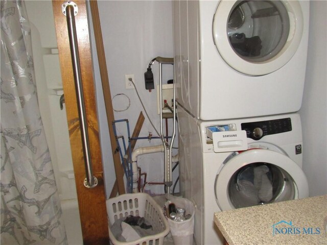 104 S Summit St, Edon, OH 43518 - clothes washing area with stacked washer / drying machine and laundry area