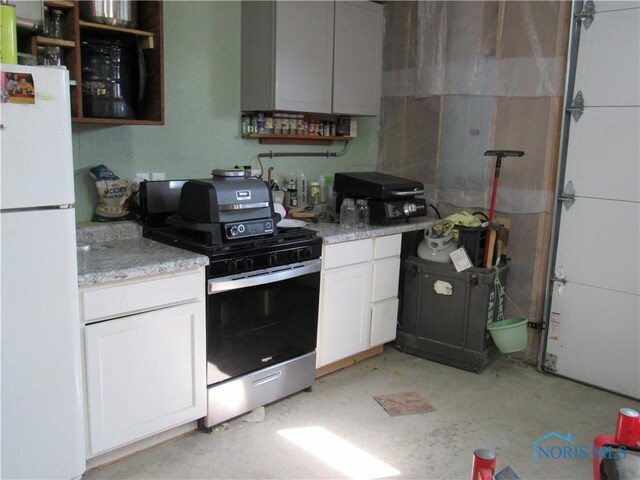 104 S Summit St, Edon, OH 43518 - kitchen featuring gas range oven, white cabinetry, open shelves, and freestanding refrigerator