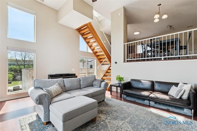 living area featuring stairway and wood finished floors