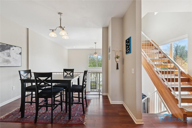 dining room featuring stairway, baseboards, and wood finished floors