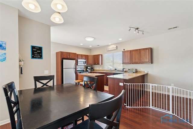 dining room featuring visible vents and dark wood-style floors