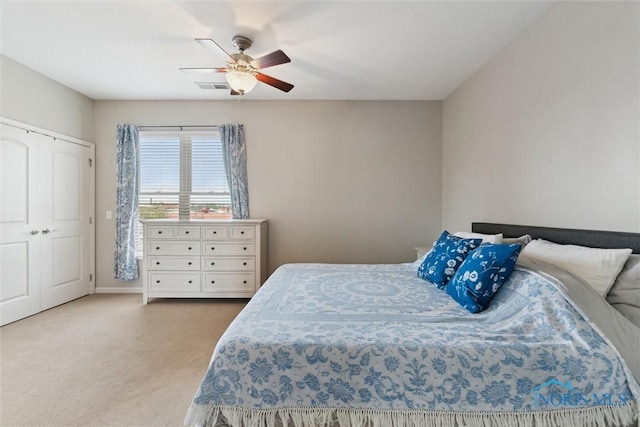 carpeted bedroom with ceiling fan, visible vents, and baseboards