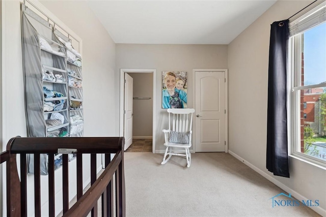 bedroom featuring light colored carpet and baseboards