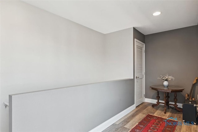 interior space with baseboards, recessed lighting, and wood finished floors