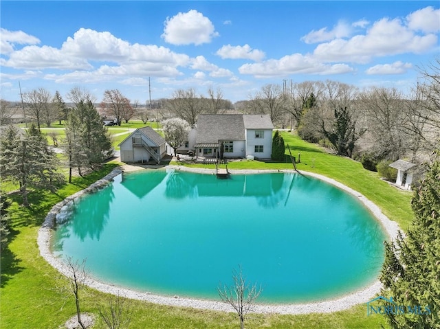 view of pool featuring a lawn, an outdoor structure, and a pool