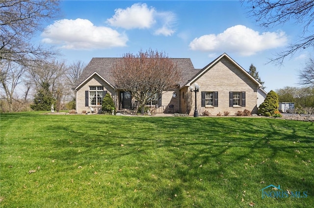 single story home featuring a front lawn and brick siding