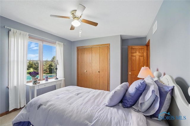 bedroom with a closet, ceiling fan, and visible vents