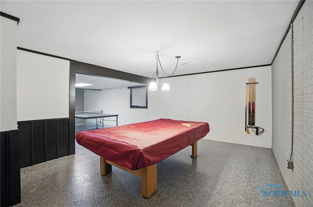rec room with speckled floor, brick wall, and billiards