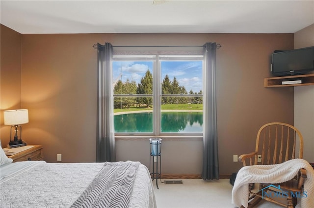 bedroom featuring carpet flooring, multiple windows, and visible vents