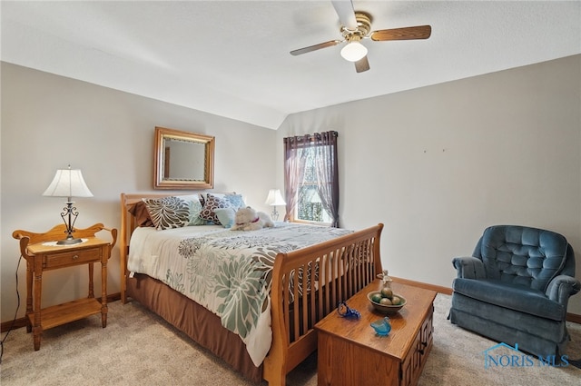 bedroom with vaulted ceiling, baseboards, light colored carpet, and ceiling fan