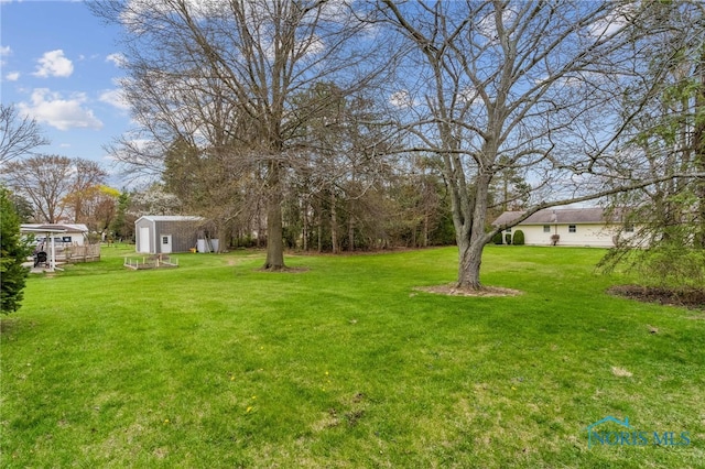 view of yard with an outbuilding and a shed