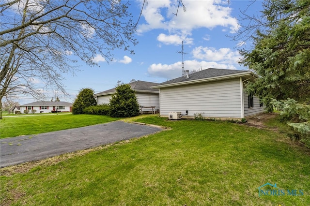 rear view of house featuring a yard