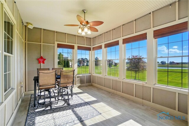 sunroom with a ceiling fan and a wealth of natural light