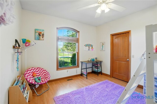 bedroom with baseboards, ceiling fan, and wood finished floors