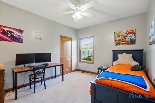 bedroom with a ceiling fan, baseboards, and light carpet