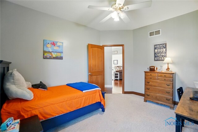 bedroom with carpet floors, a ceiling fan, baseboards, and visible vents