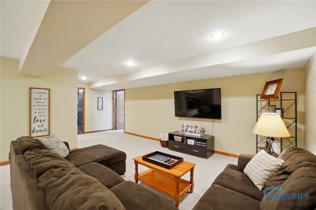 carpeted living area with recessed lighting and baseboards