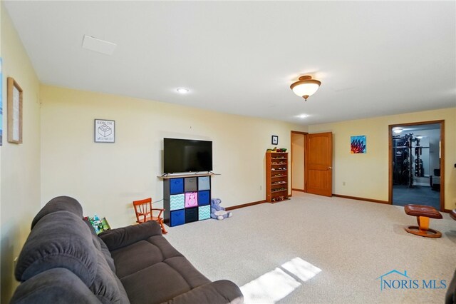 carpeted living room featuring baseboards