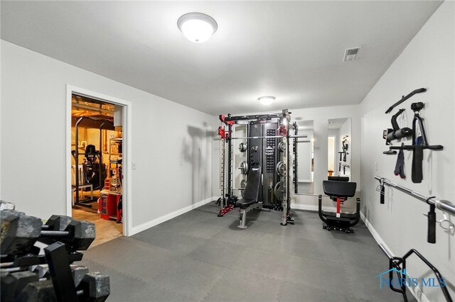 workout room featuring baseboards and visible vents