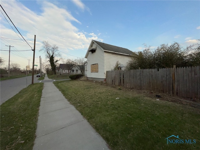 2398 York St, Toledo, OH 43605 - view of side of home with fence and a lawn