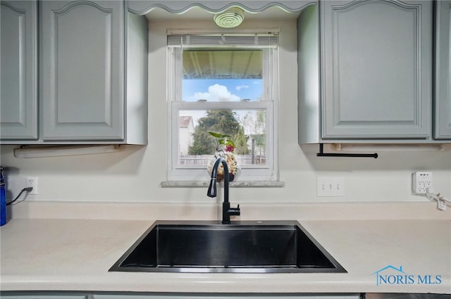 kitchen featuring a sink and light countertops