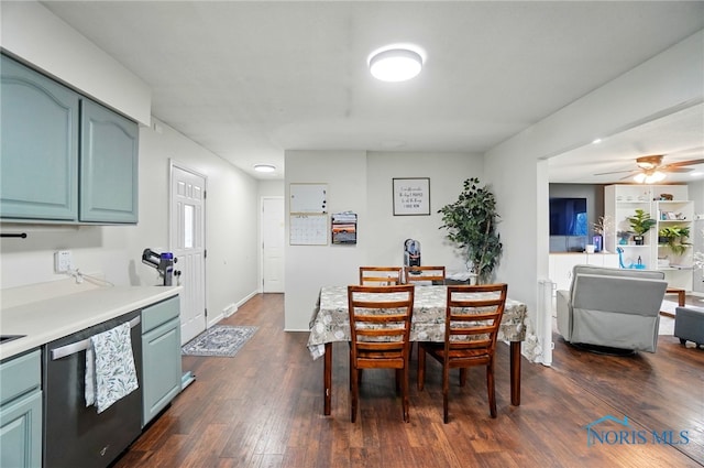 dining area with baseboards, dark wood-style flooring, and ceiling fan