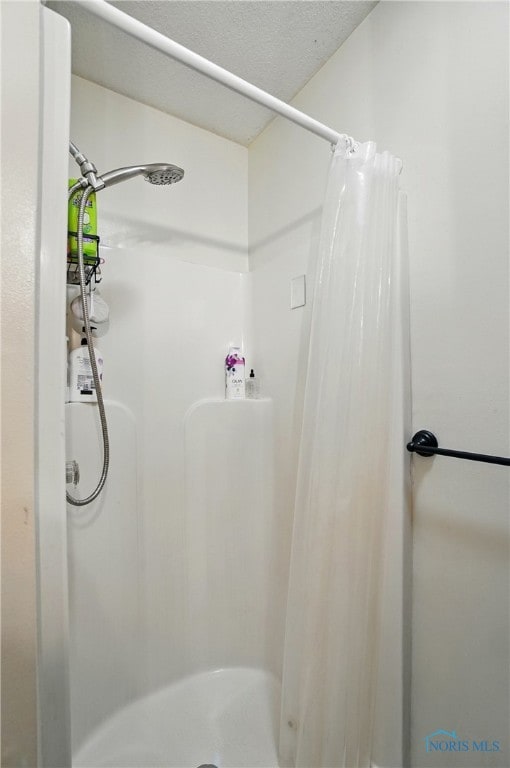 bathroom featuring a shower stall