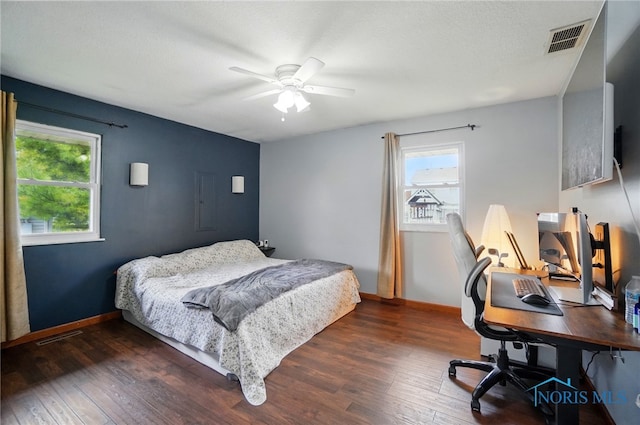 bedroom featuring visible vents, baseboards, and hardwood / wood-style floors